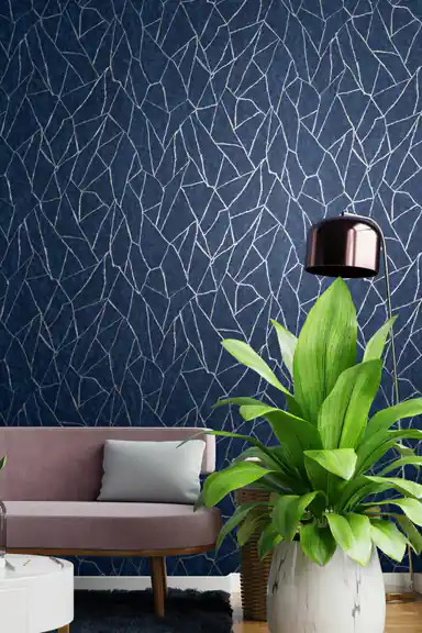 Partially unrolled navy wallpaper roll showing silver abstract line pattern on deep blue textured surface