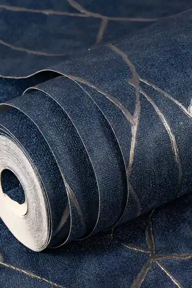 Room scene with navy abstract wallpaper installed behind mauve sofa, copper pendant lamp, and tropical green plant
