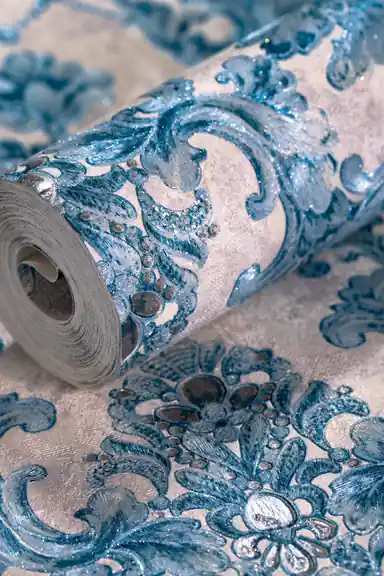 Rolled teal blue baroque wallpaper showing embossed damask pattern with glitter accents on light background
