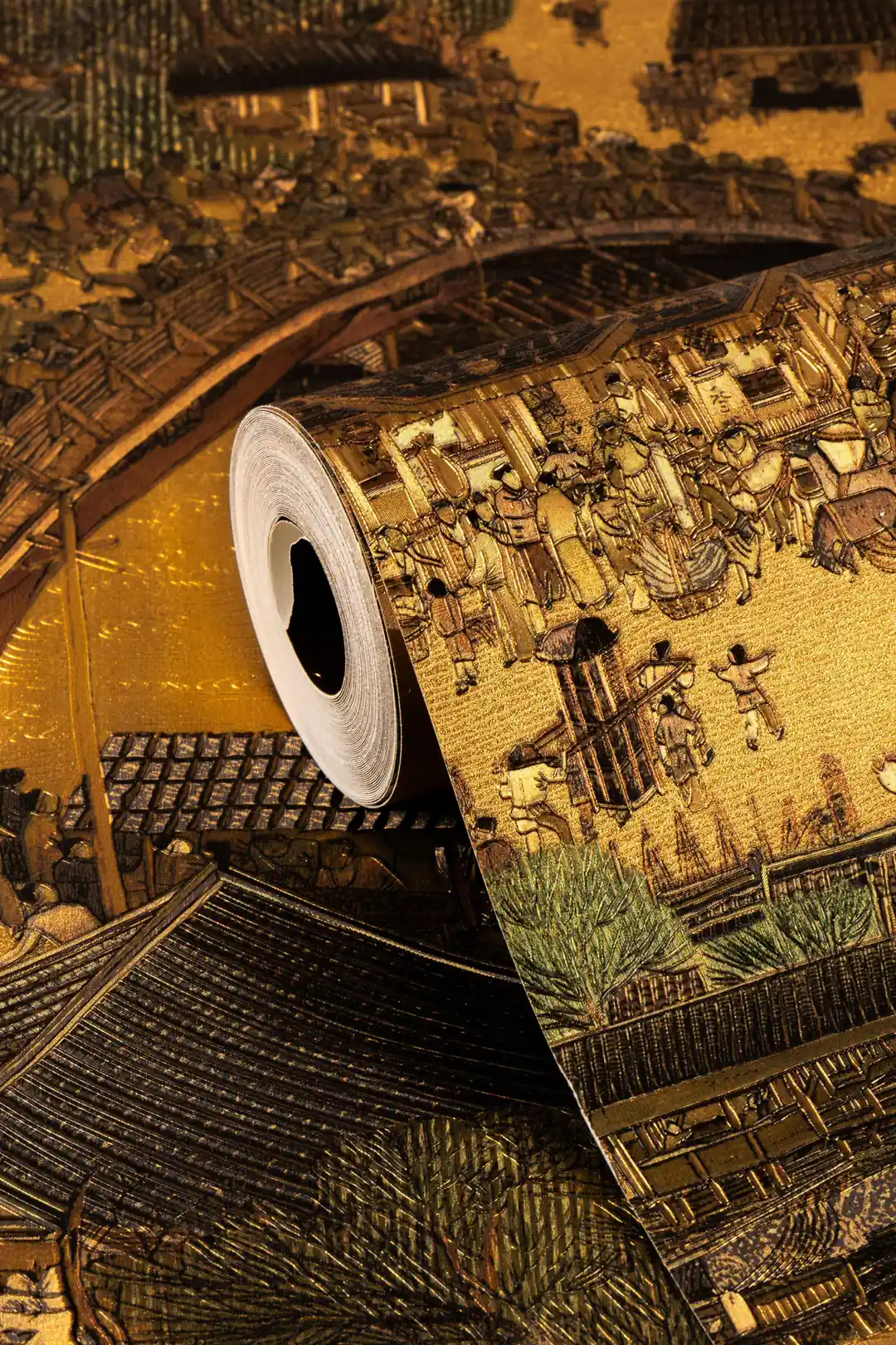 Rolled ancient golden village mural wallpaper showing detailed Chinese townscape with metallic gold finish