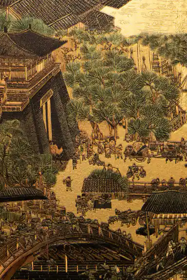 Close-up of golden village mural detail showing pagoda rooftops, pine trees, and bridge over river
