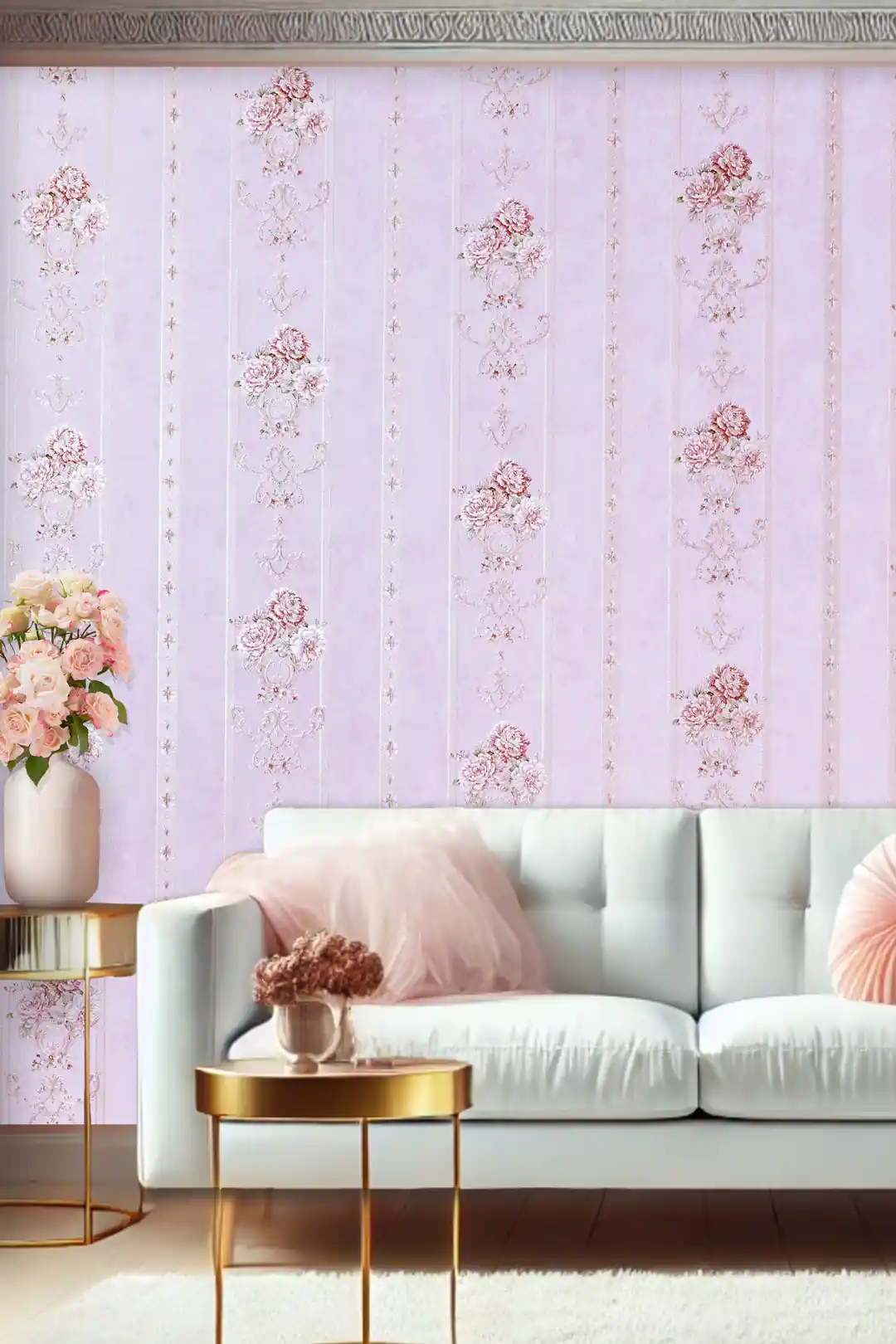 Living room with pink floral stripe wallpaper behind white sofa with blush cushions and gold accents