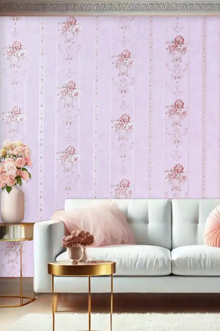 Living room with pink floral stripe wallpaper behind white sofa with blush cushions and gold accents