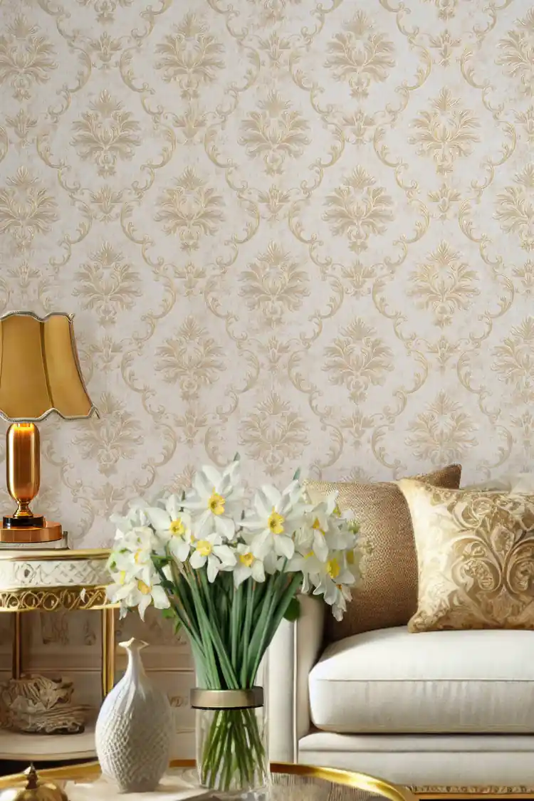 Installed wall with gold baroque damask wallpaper behind elegant lamp with white flowers in a vase