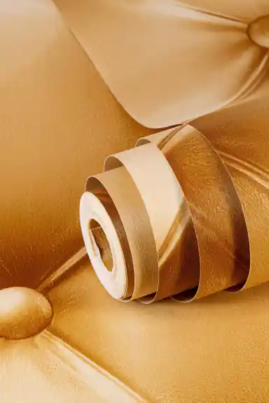 Close-up of rolled caramel leather button-tufted wallpaper showing realistic 3D quilted cushion effect