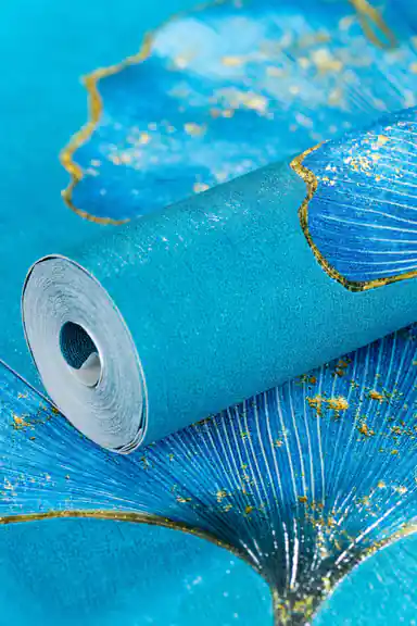Rolled teal ginkgo wallpaper showing blue fan-shaped leaves with metallic gold foil stems on teal base