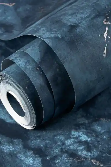 Rolled midnight blue marble wallpaper showing deep navy surface with silver vein finish