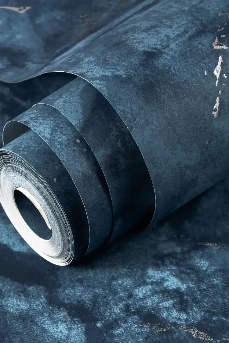 Rolled midnight blue marble wallpaper showing deep navy surface with silver vein finish