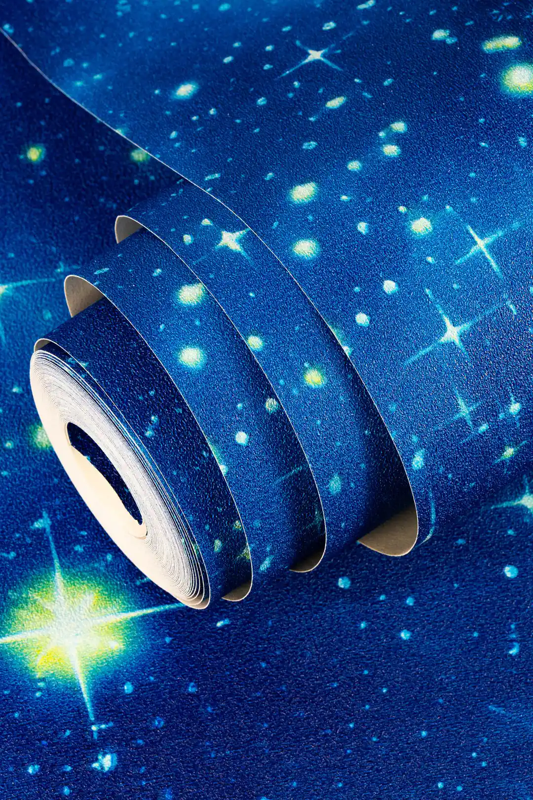 Rolled deep blue galaxy wallpaper showing glowing stars and nebula pattern up close
