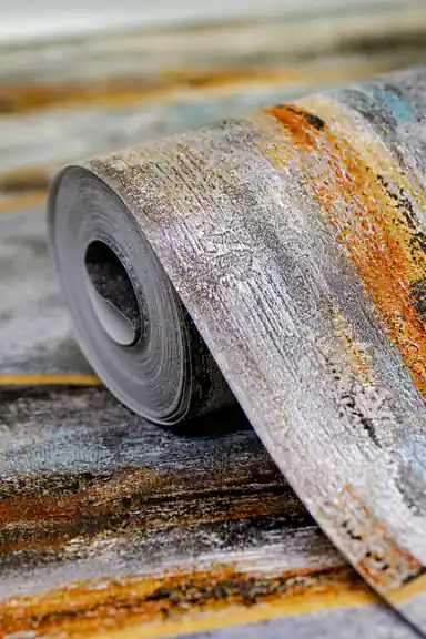 Abstract brush stroke wallpaper installed in living room showing grey, rust and blue textured panels with gold borders