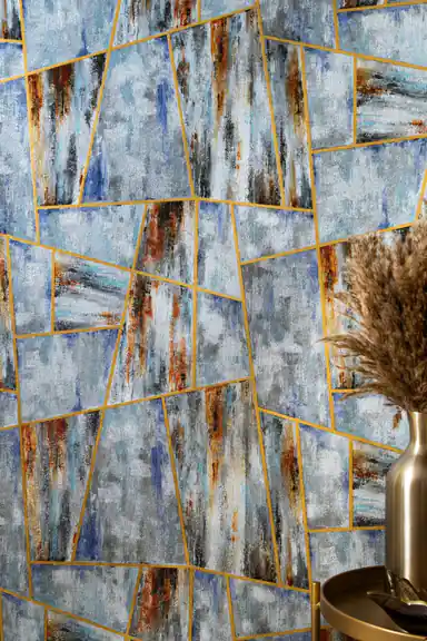 Abstract geometric pattern wallpaper with gold line accents behind decorative pampas grass vase