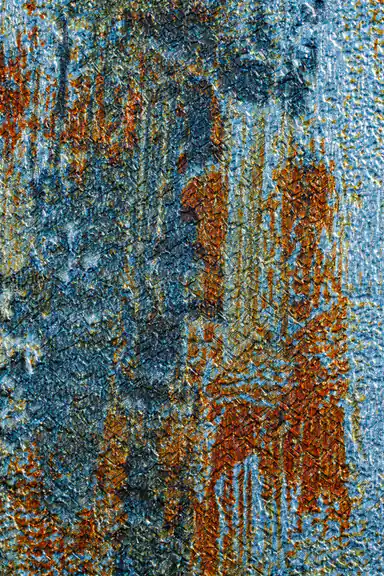 Macro texture detail of teal wallpaper showing rough brush strokes with gold and rust accents