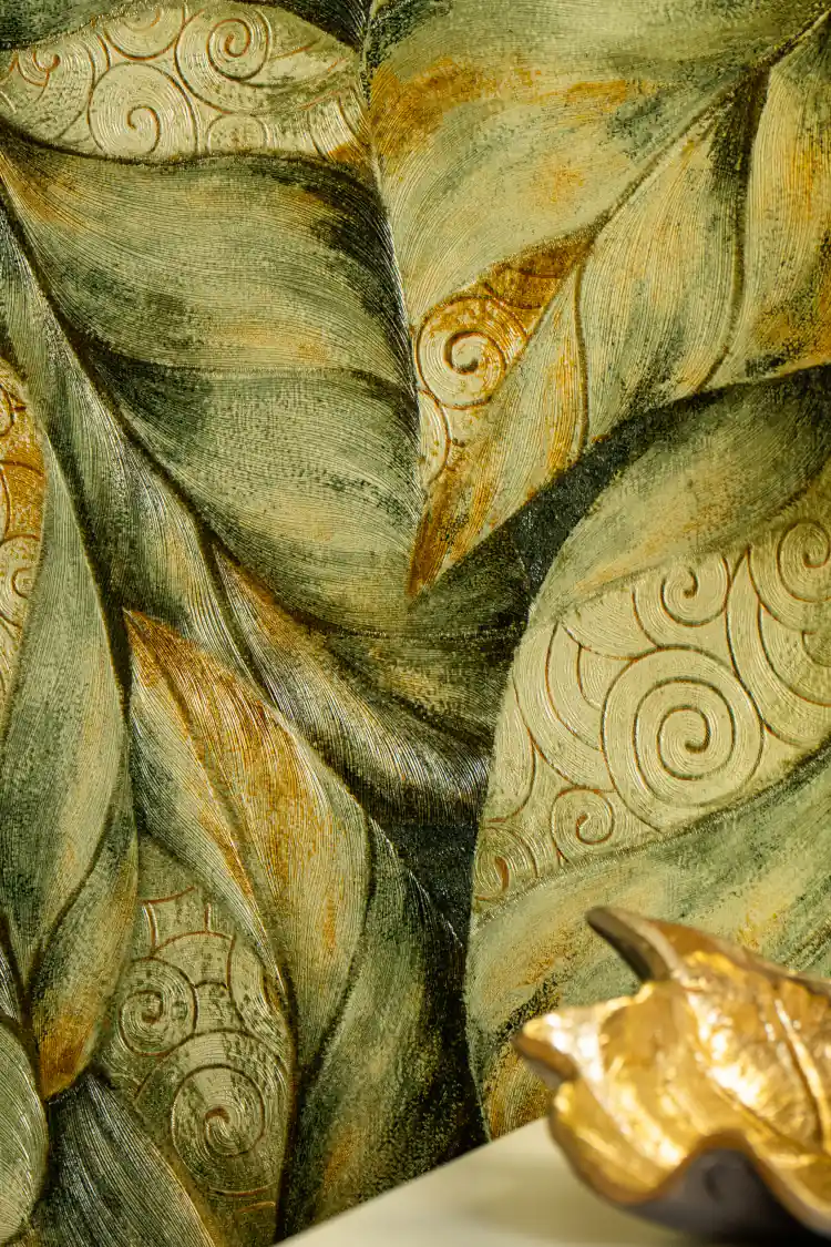 Embossed green and gold swirl leaf pattern wallpaper installed on wall with teal base and floral motifs