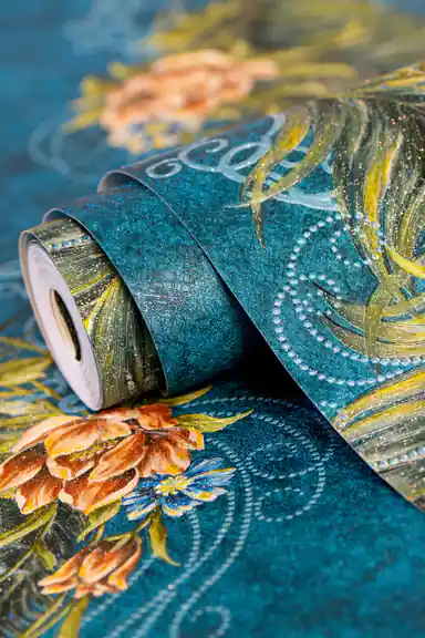 Teal peacock feather wallpaper roll showing embossed floral and feather design with glitter detail