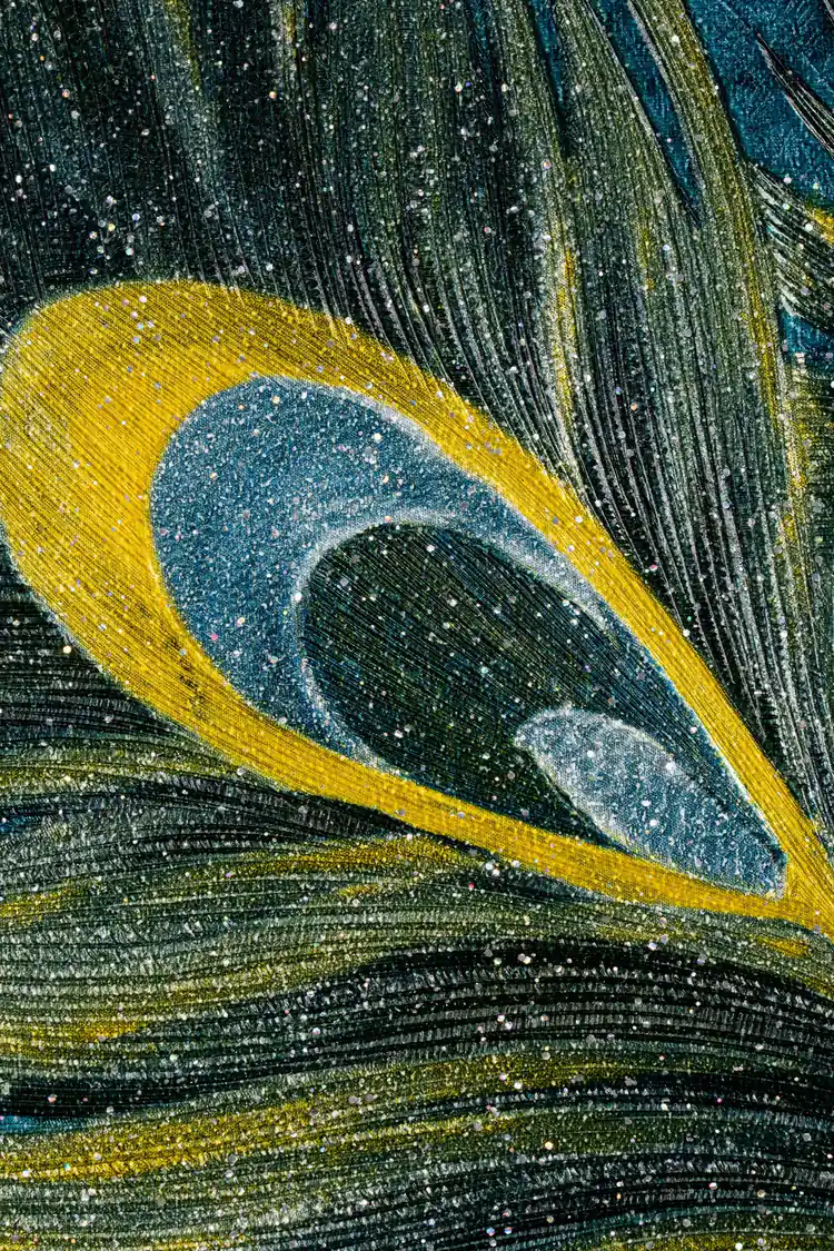 Extreme macro of peacock eye feather detail with gold and teal iridescent glitter texture