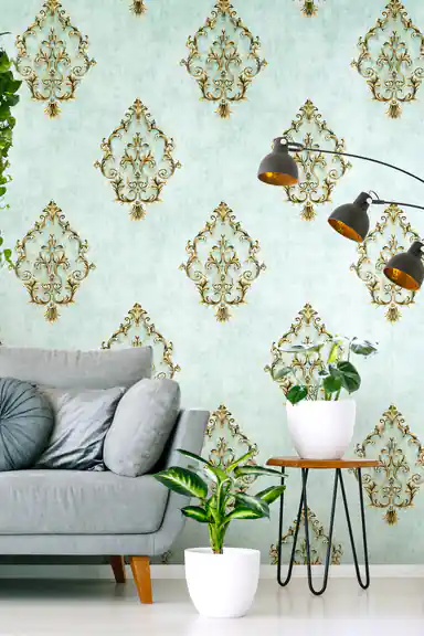 Sage green damask wallpaper in modern living room with grey sofa, plant stand and industrial lamp