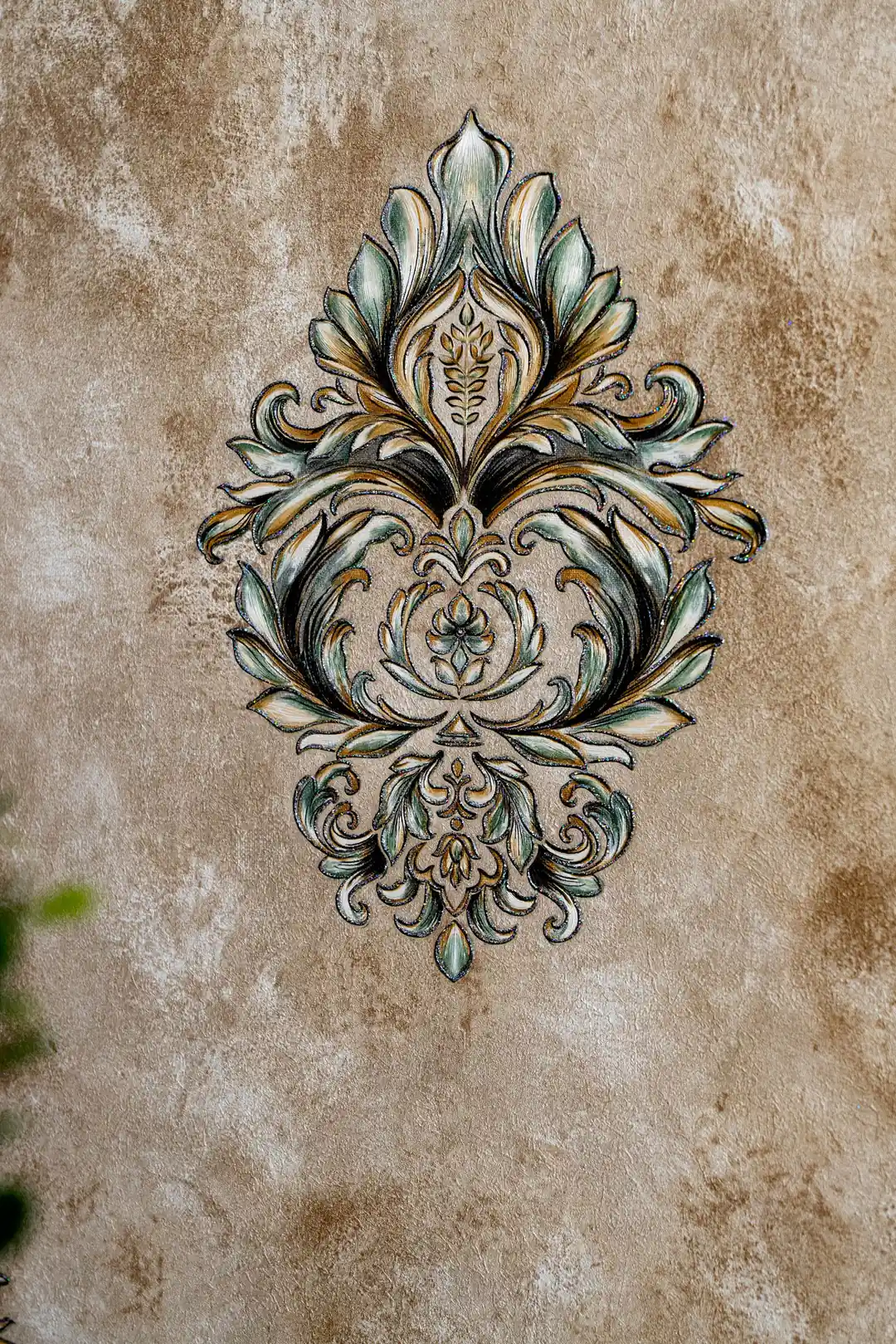 Close-up of single Venetian damask motif showing intricate teal and gold scrollwork detail