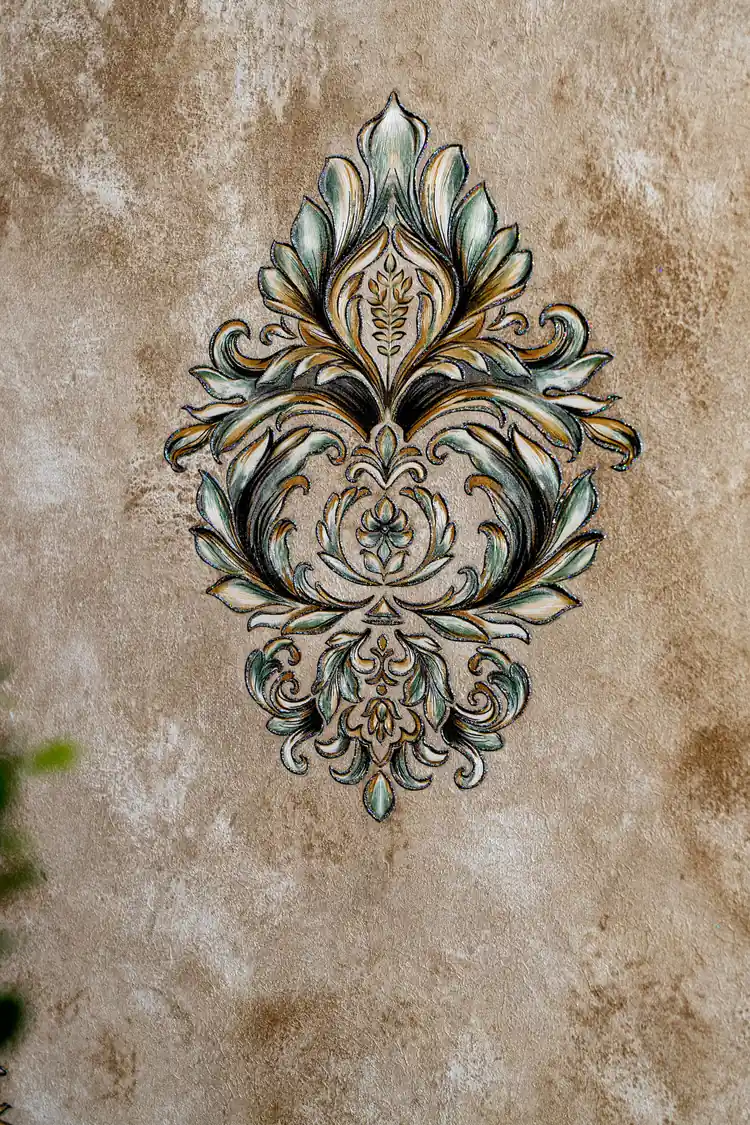 Close-up of single Venetian damask motif showing intricate teal and gold scrollwork detail