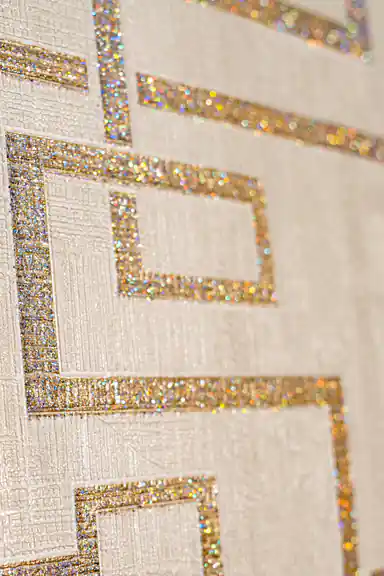 Close-up of holographic gold glitter maze pattern showing sparkling interlocking square details