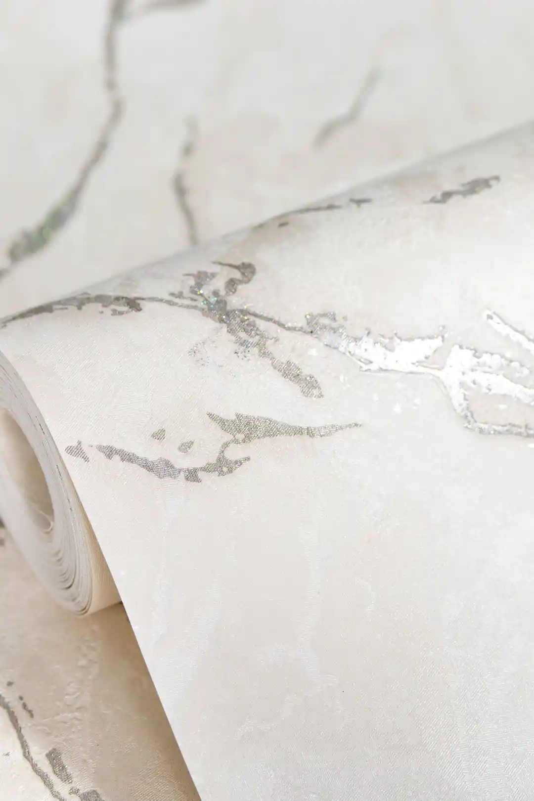 White Carrara marble wallpaper roll with delicate silver shimmer veins on pristine white base
