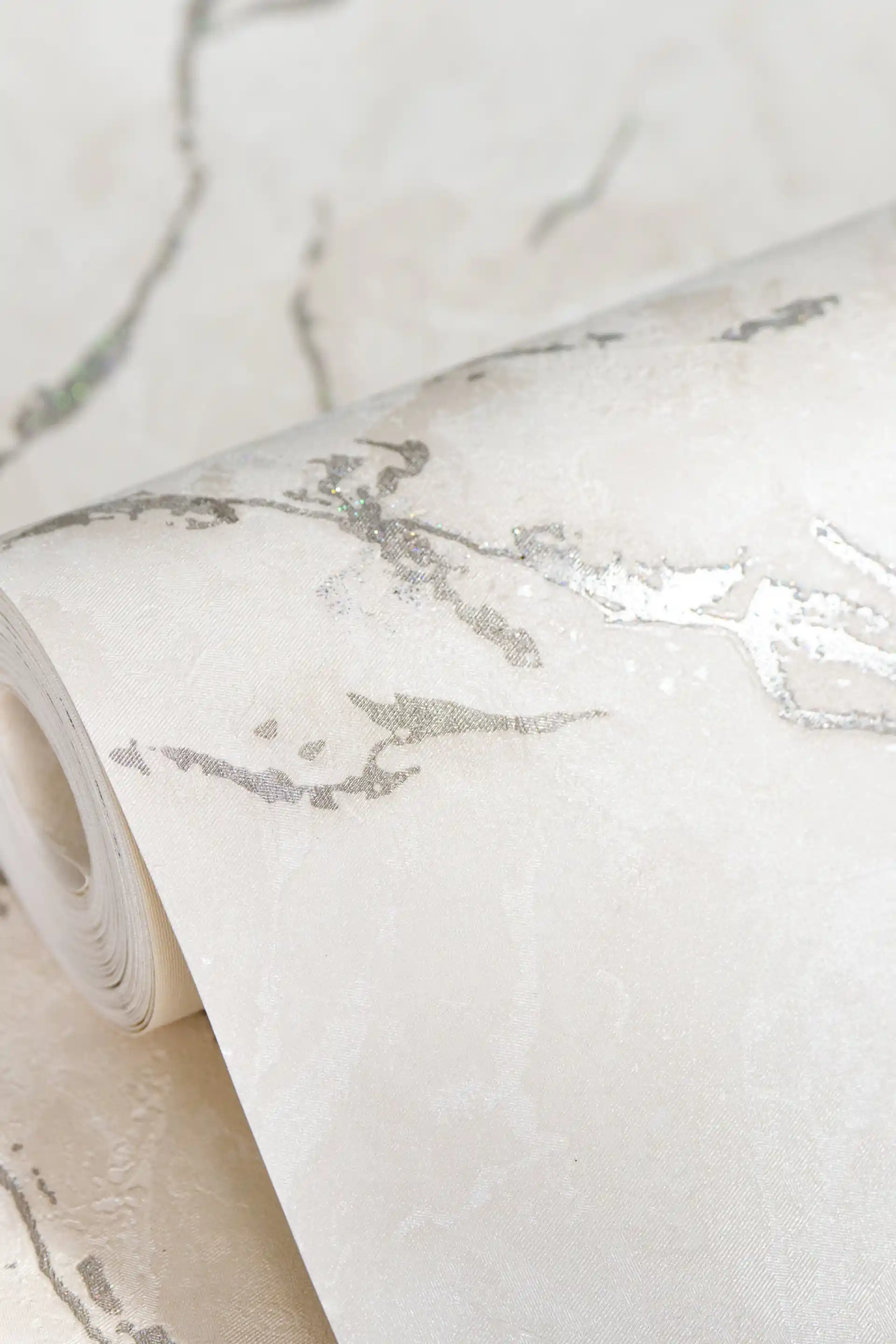 White Carrara marble wallpaper roll with delicate silver shimmer veins on pristine white base