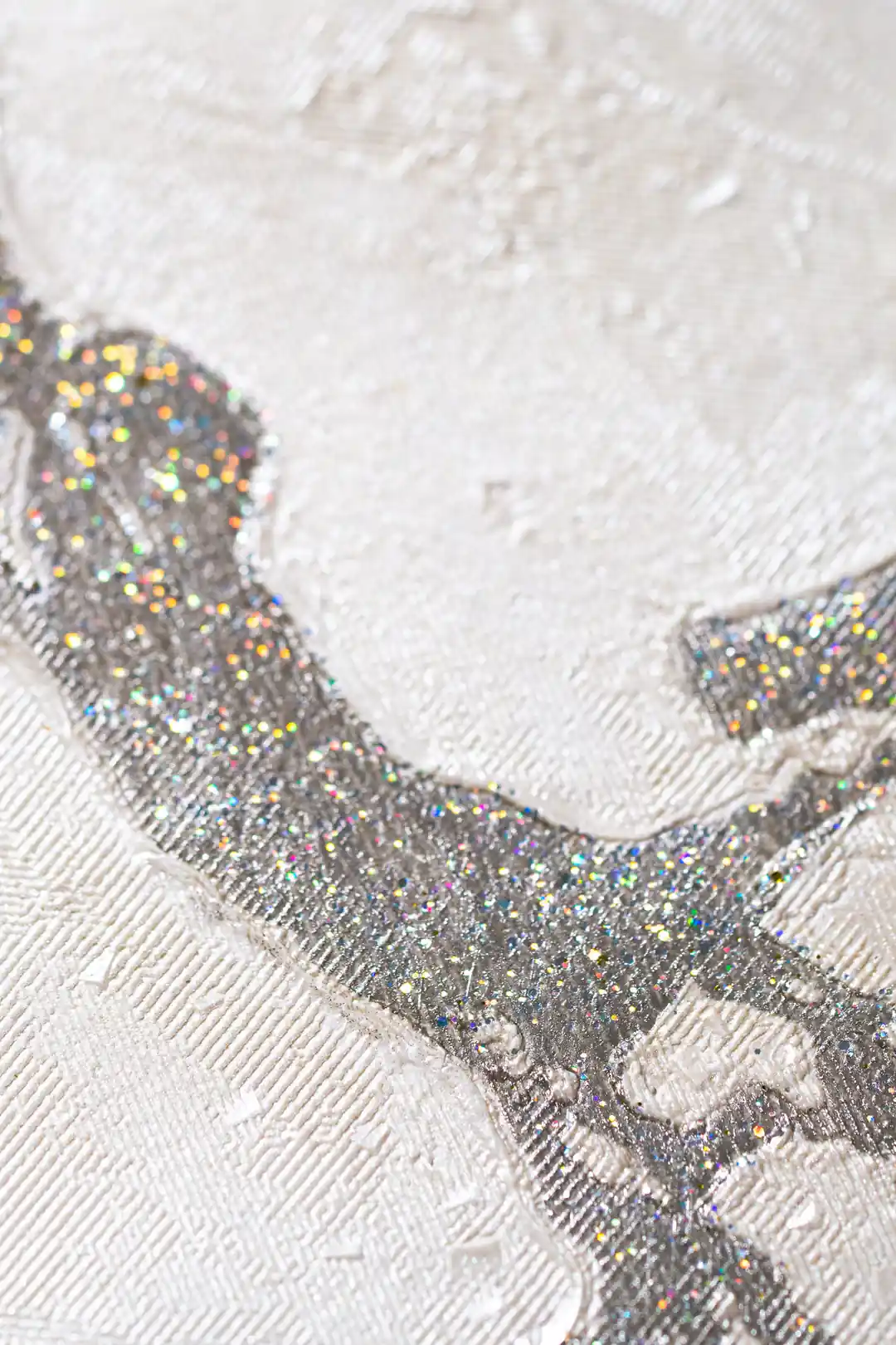 Extreme macro of silver holographic glitter vein detail on white embossed marble wallpaper surface