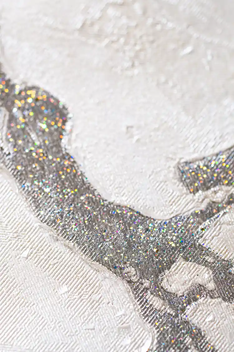 Extreme macro of silver holographic glitter vein detail on white embossed marble wallpaper surface