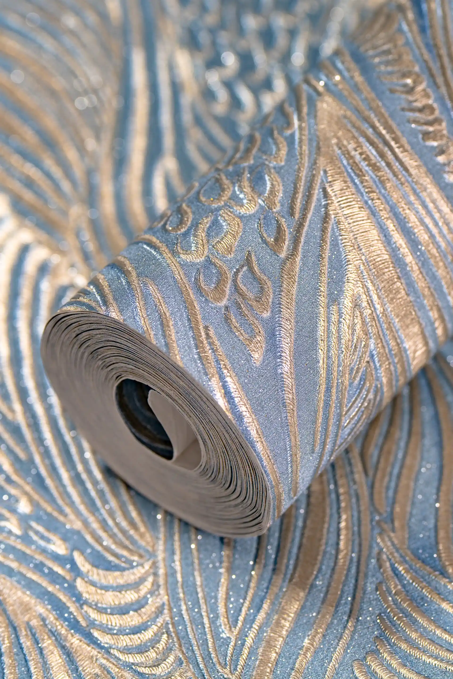 Blue swirl feather pattern wallpaper roll with embossed silver glitter on light blue base