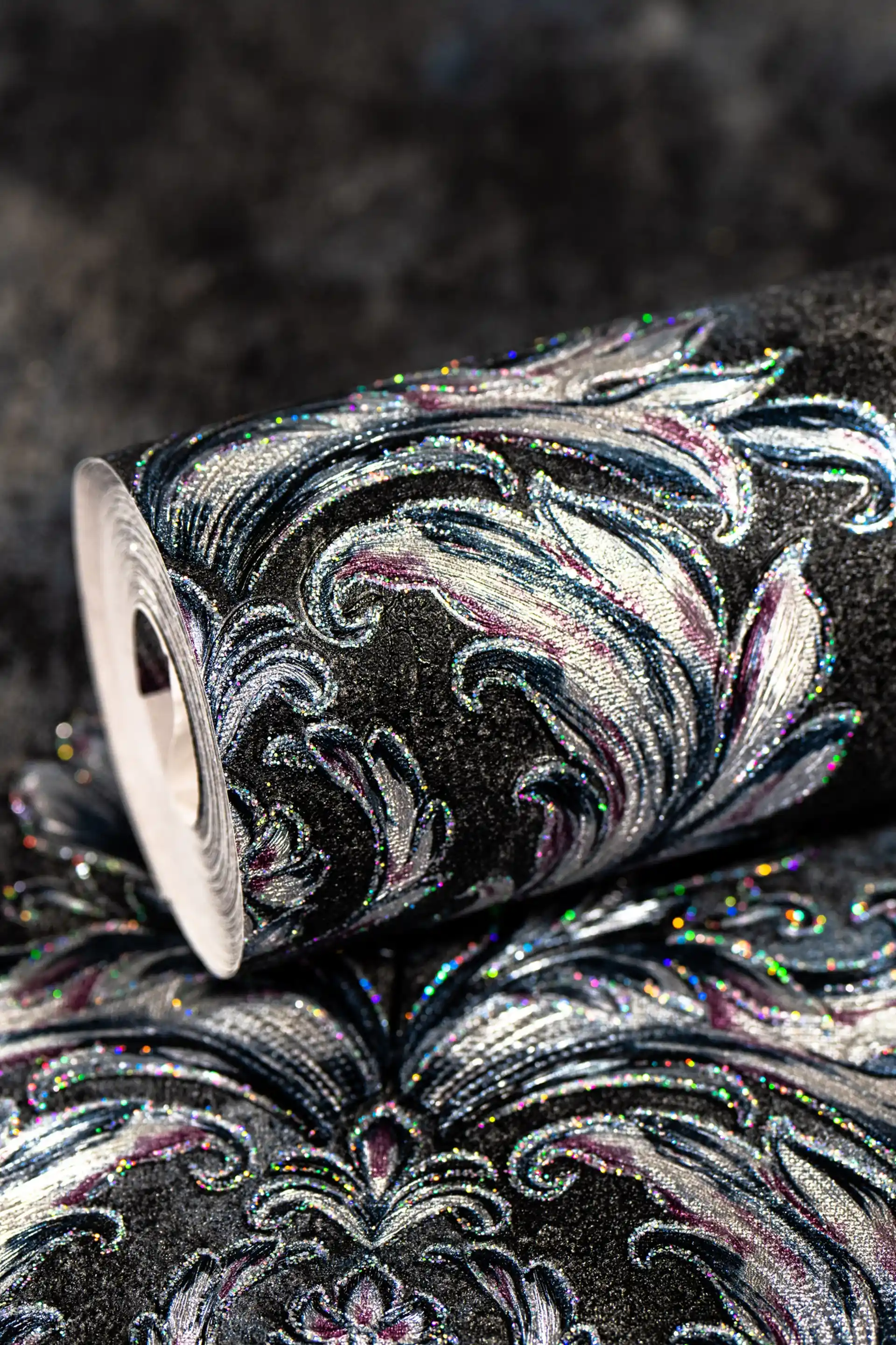 Black damask wallpaper roll with silver baroque motifs and holographic glitter finish