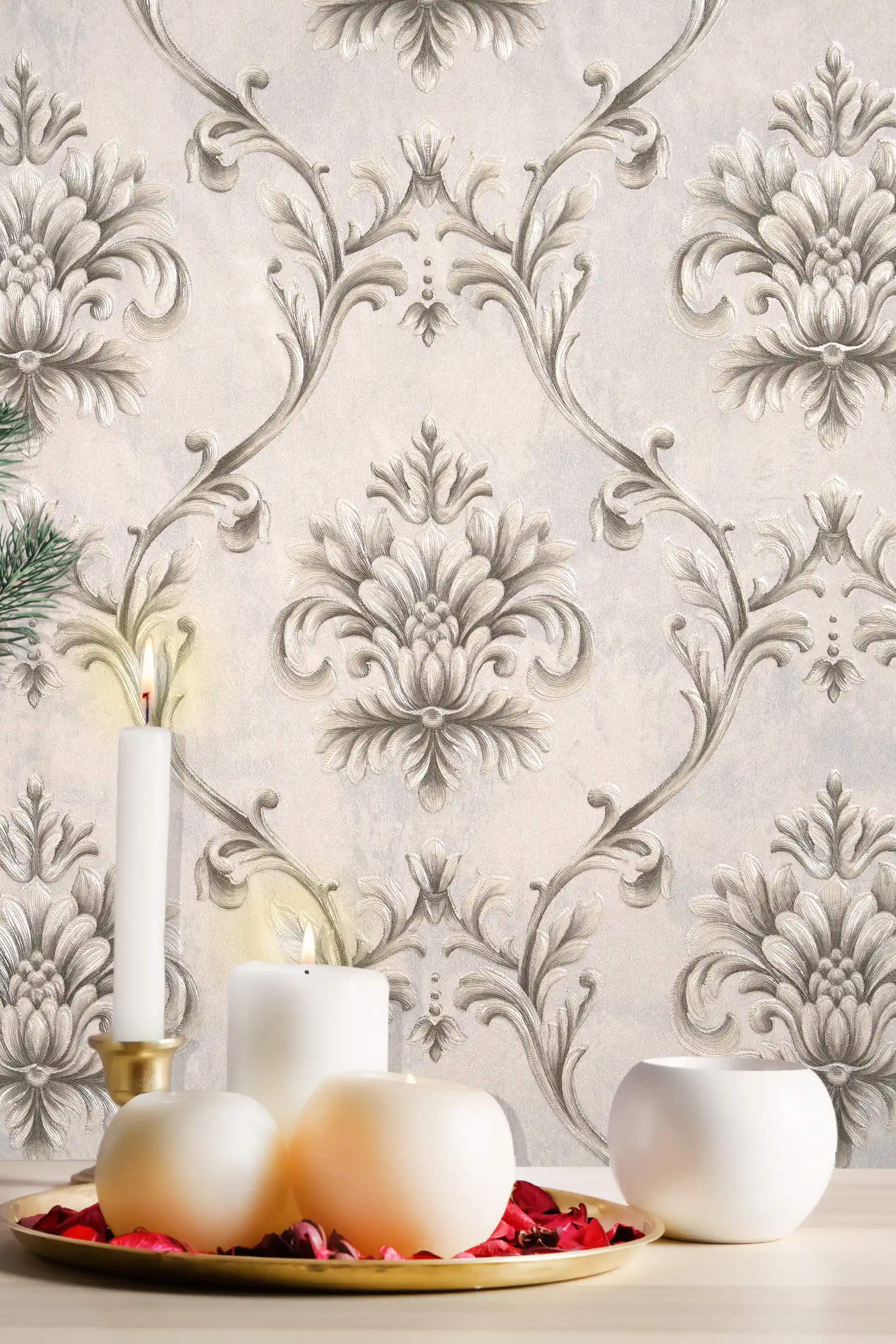 Grey embossed damask wallpaper installed on wall with candle display, ceramic vases and rose petals