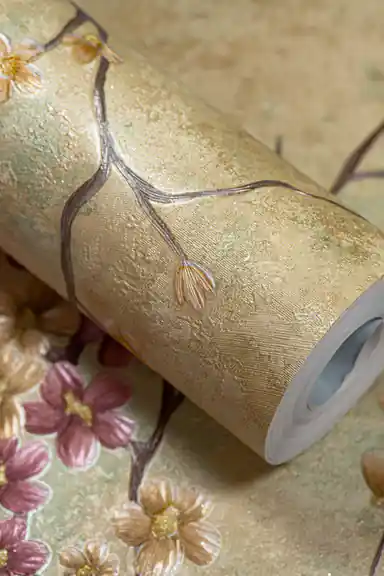 Floral wallpaper roll showing golden textured base with blooming cherry blossom branch pattern