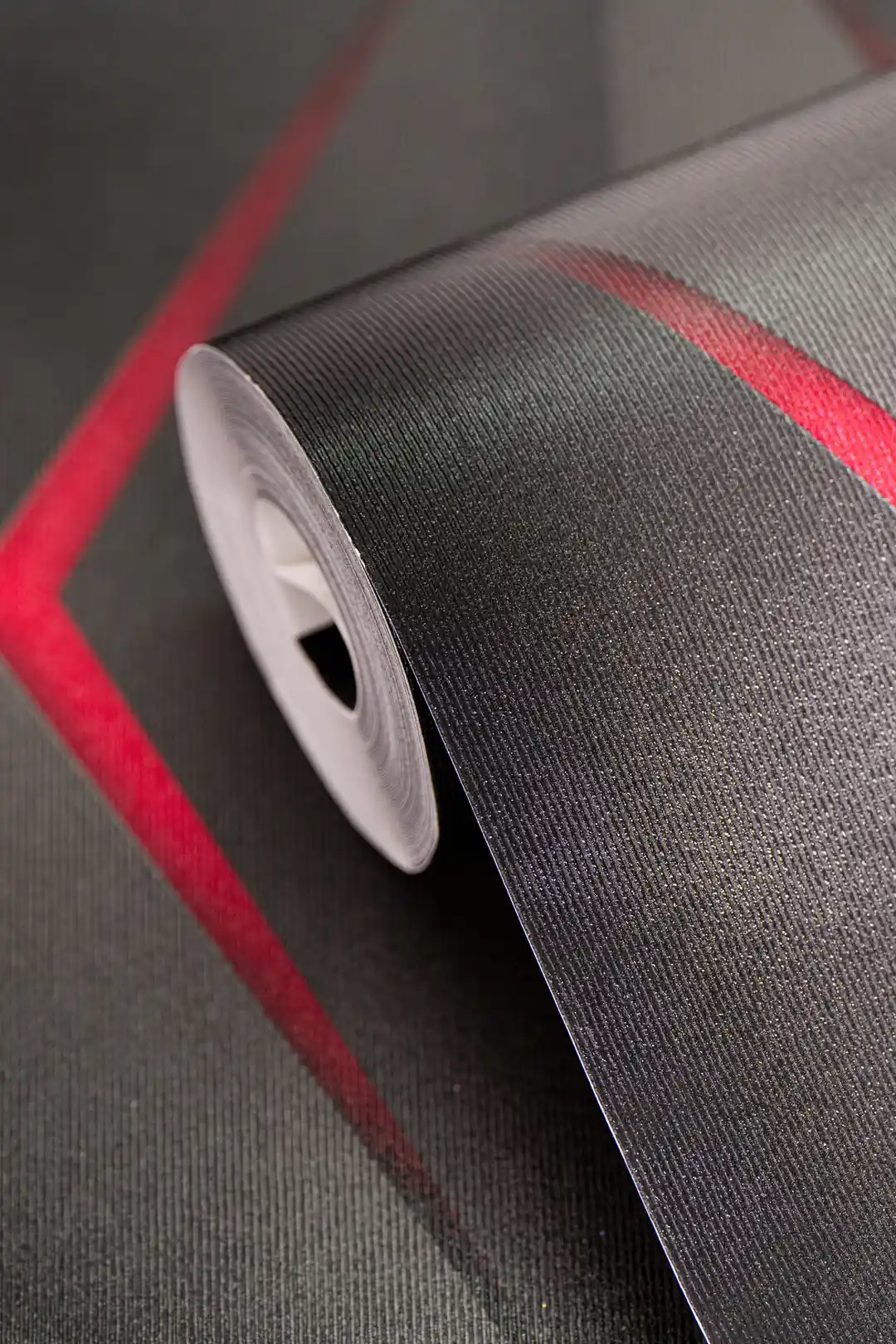 Dark grey 3D hexagon wallpaper roll with glowing red neon lines on a textured surface