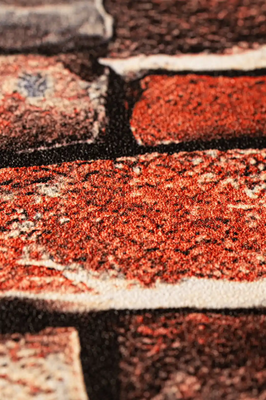 Extreme close-up macro of the embossed brick texture showing red and brown surface detail