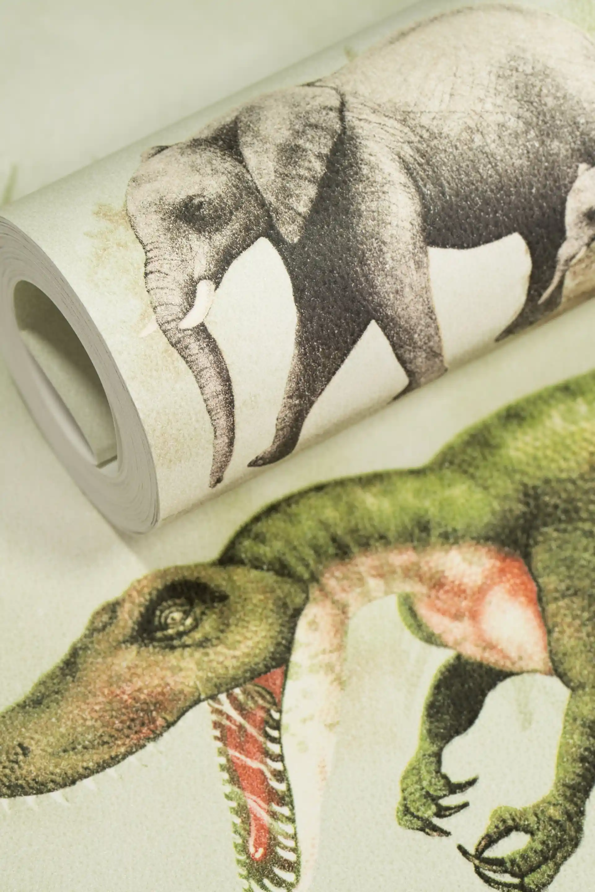 Kids dinosaur wallpaper roll featuring illustrated T-Rex, elephants, and prehistoric creatures on a white background