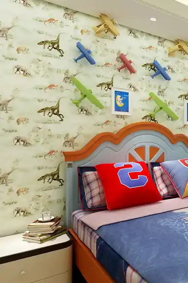 Boy's bedroom with dinosaur wallpaper installed behind a blue bed with colorful toy airplanes on the wall