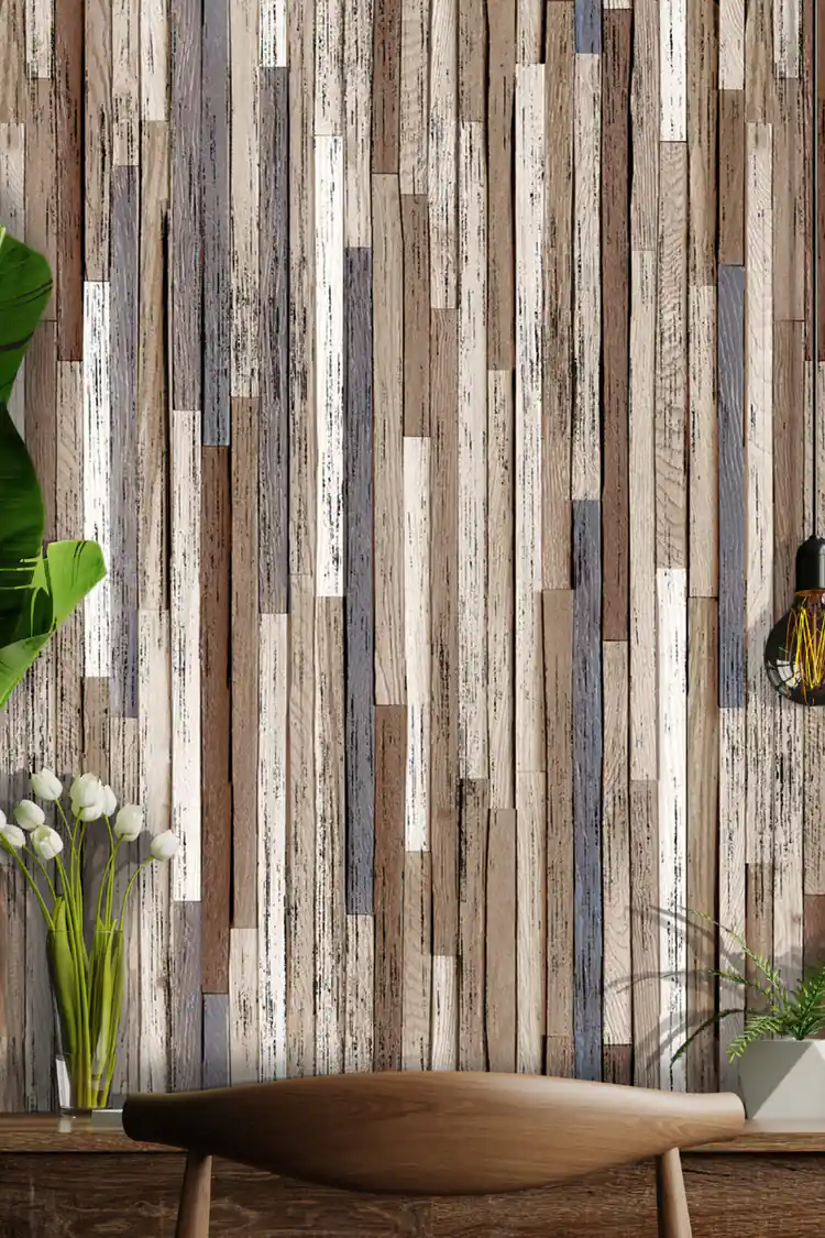 Full wall view of weathered wood plank wallpaper with wooden table, monstera plant, and flower arrangement