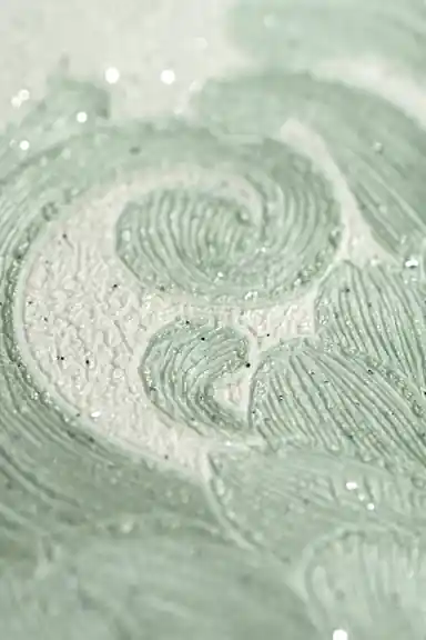 Extreme macro of the glittering embossed swirl pattern revealing sparkling texture on the green wallpaper