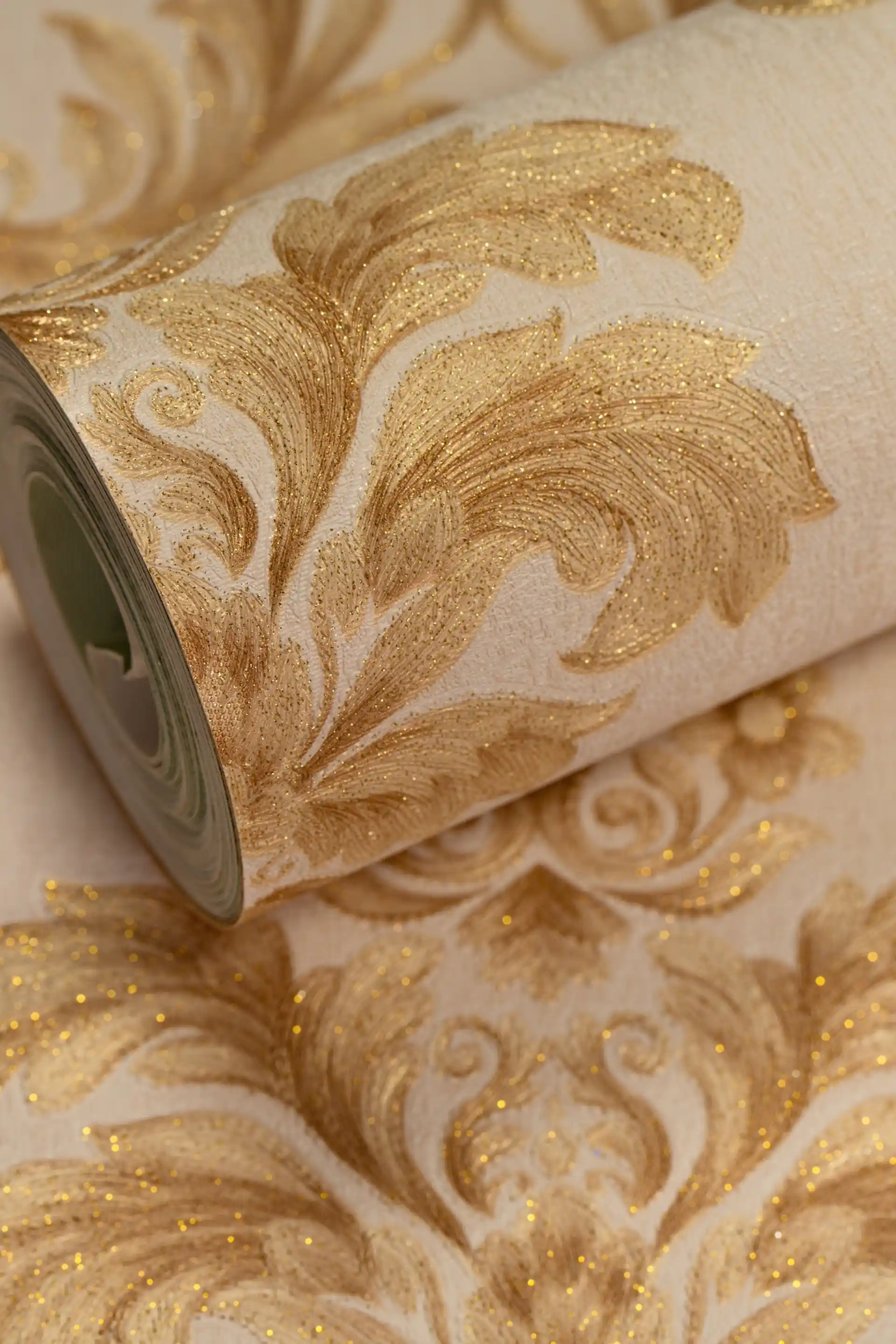 Premium gold floral leaf damask wallpaper roll with heavy embossed glitter on a cream background