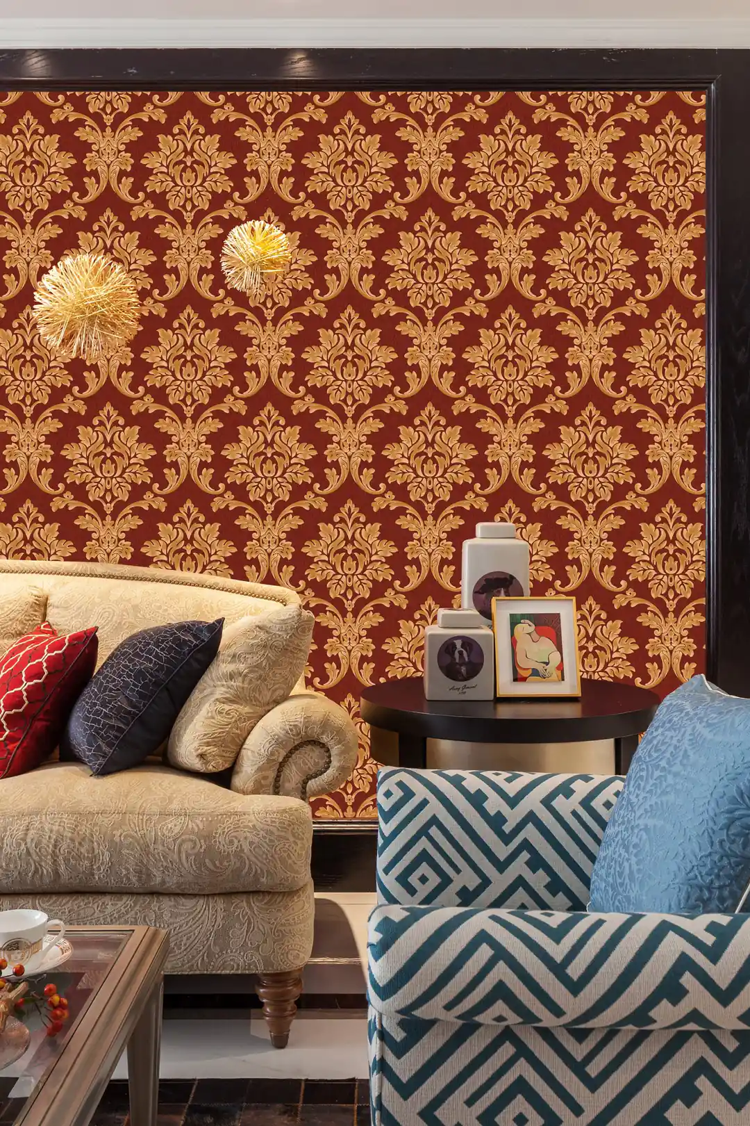 Luxurious living room with red and gold damask wallpaper behind a classic sofa with decorative cushions