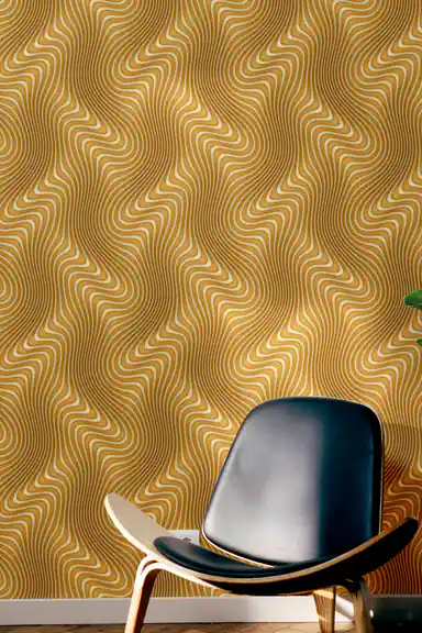 Room scene with gold wavy line wallpaper installed behind a dark modern chair on a dark floor