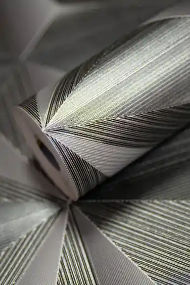 Silver geometric fan pattern wallpaper roll with 3D triangular facets and metallic shimmer finish