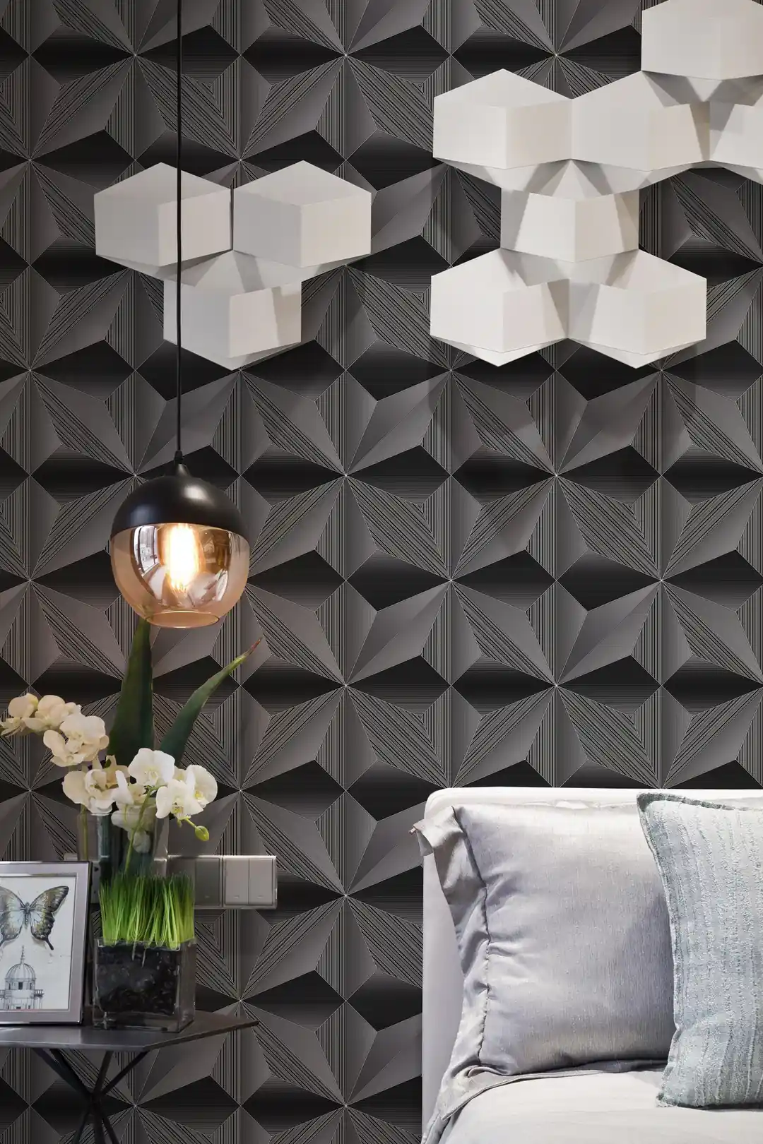 Modern living room with dark 3D geometric fan wallpaper behind a grey sofa, hexagonal lamp, and copper light