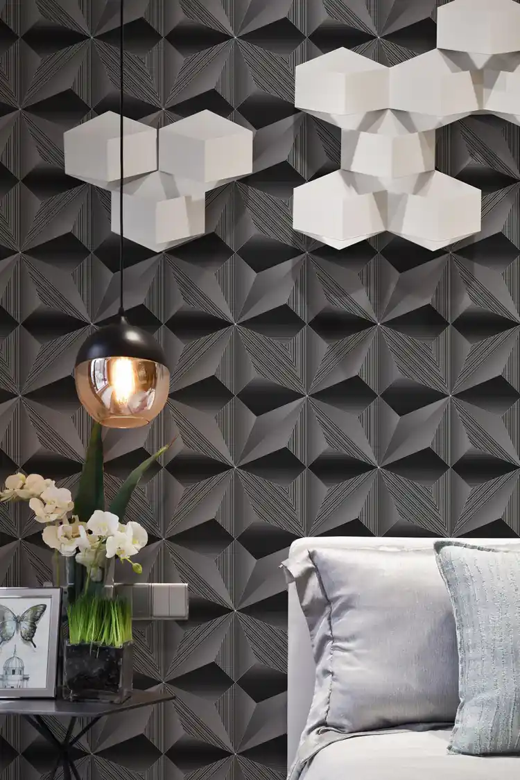 Modern living room with dark 3D geometric fan wallpaper behind a grey sofa, hexagonal lamp, and copper light