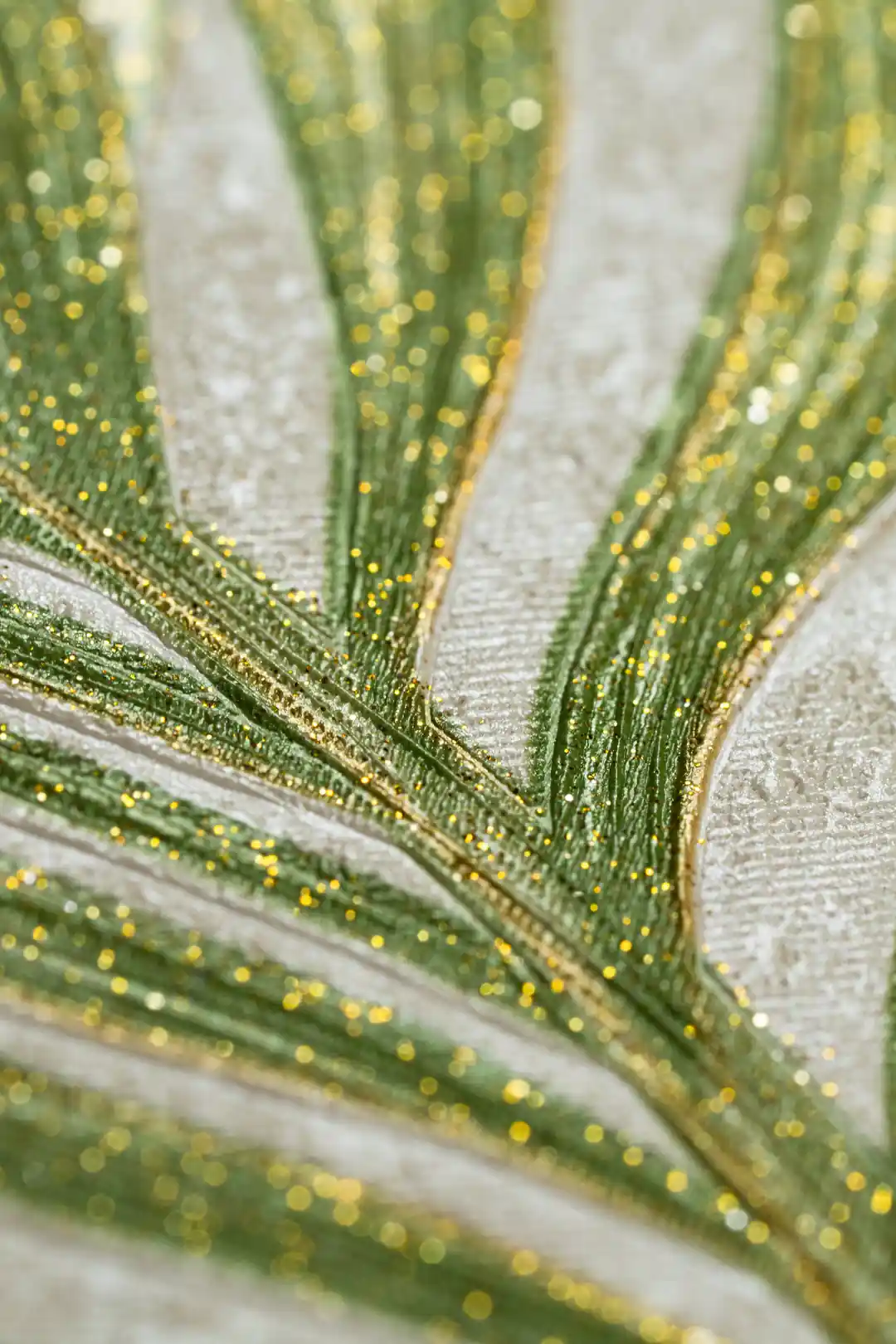 Extreme close-up showing sparkling gold glitter particles along green palm leaf veins on wallpaper