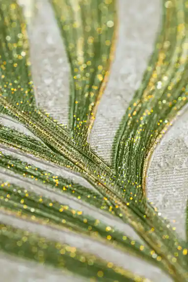 Extreme close-up showing sparkling gold glitter particles along green palm leaf veins on wallpaper