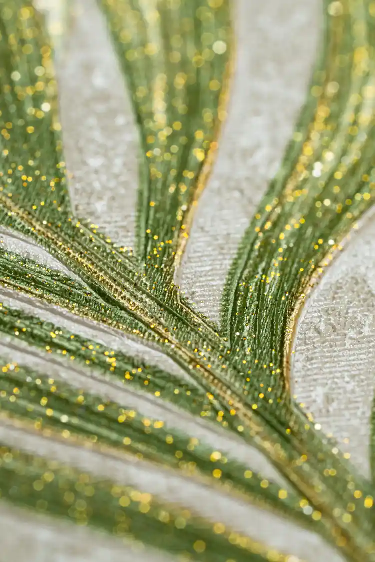 Extreme close-up showing sparkling gold glitter particles along green palm leaf veins on wallpaper