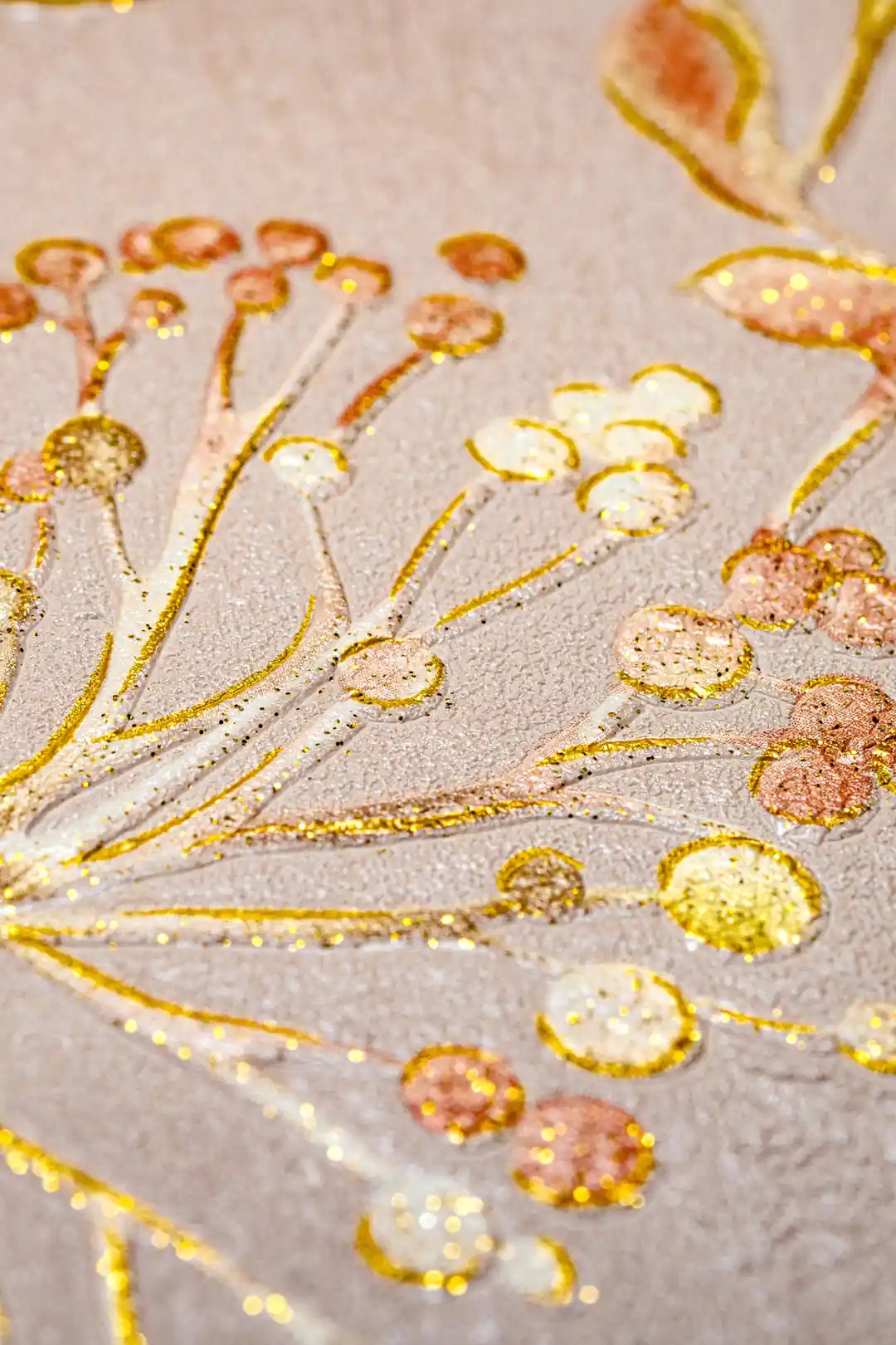 Macro close-up of gold glitter berry clusters and leaf details on warm tan botanical wallpaper