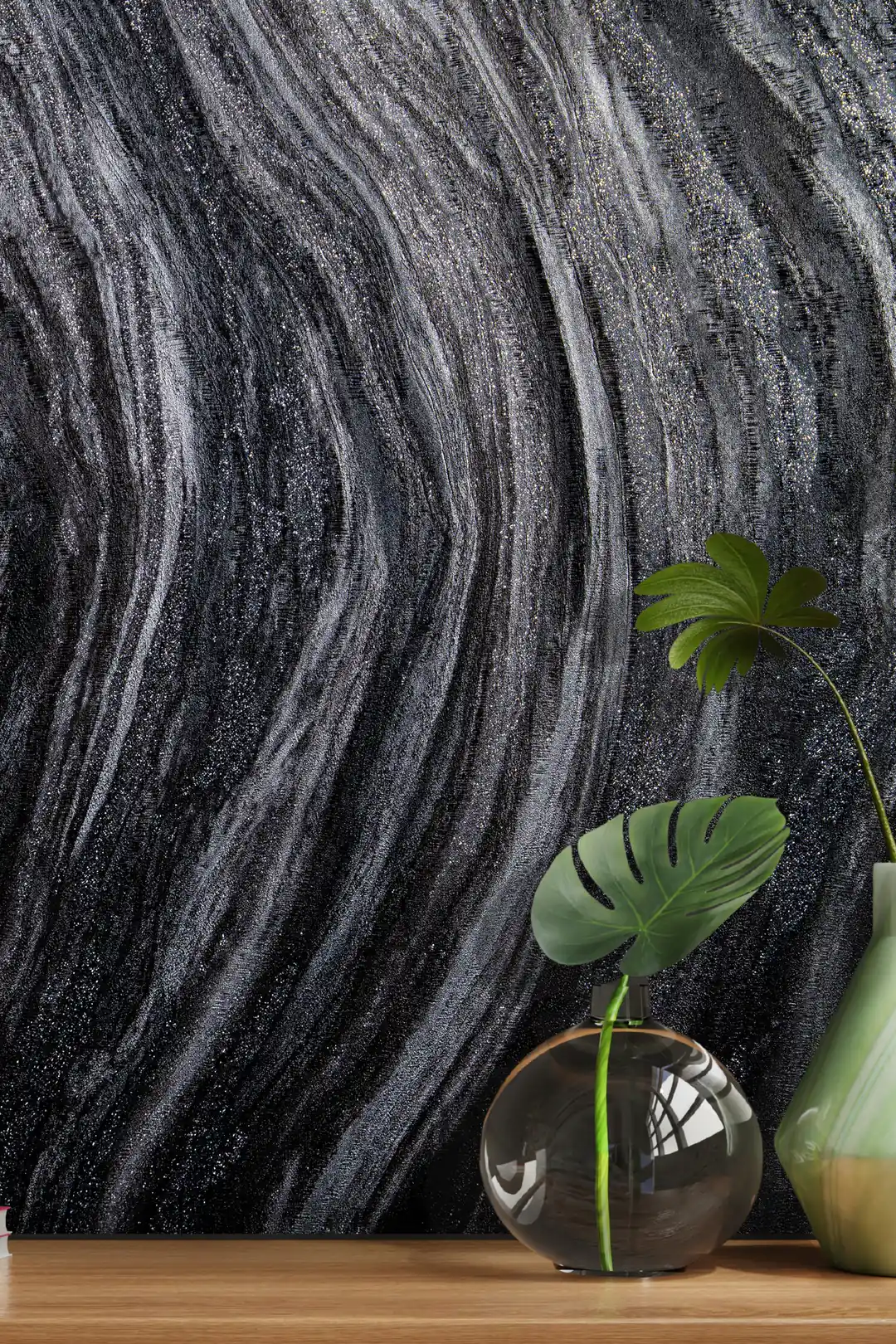 Installed wall view of black marble swirl wallpaper with a monstera plant in a glass vase on wooden shelf