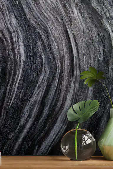 Installed wall view of black marble swirl wallpaper with a monstera plant in a glass vase on wooden shelf