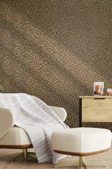 Cozy living room with bronze metallic leaf wallpaper behind a cream lounge chair and wooden nightstand